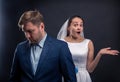 Thoughtful groom and surprised bride studio photo