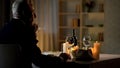 Thoughtful handsome gentleman waiting for woman, sitting at served table, date Royalty Free Stock Photo