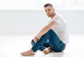 Thoughtful handsome man portrait sitting on floor