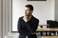 Thoughtful handsome manager man in formal suit posing in office Royalty Free Stock Photo