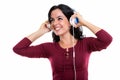 Thoughtful happy Spanish woman smiling while listening to music