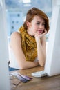 thoughtful hipster businesswoman concentrating on her computer