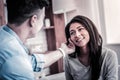 Thoughtful husband gently touching face of his wife