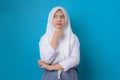 Indonesian Schoolgirl wears uniform and looking away at copy space, dreaming, thinking, choosing, advertising standing isolated on Royalty Free Stock Photo