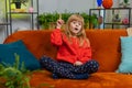 Thoughtful inspired child girl kid make Eureka gesture raises finger came up with creative plan