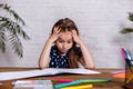 Thoughtful little girl at the table draw with crayons Royalty Free Stock Photo