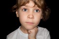 Thoughtful little girl in white T-shirts isolated