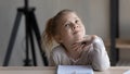 Thoughtful little kid girl considering difficult school task. Royalty Free Stock Photo