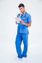 Thoughtful male doctor holding tablet compute