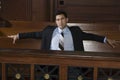 Thoughtful Male Lawyer Sitting In Courtroom