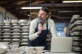 Thoughtful male potter working at worktop Royalty Free Stock Photo