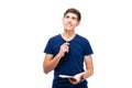 Thoughtful male student holding book