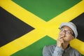 Thoughtful man against Jamaican flag