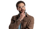 thoughtful man with glasses touching chin and thinking and looking away Royalty Free Stock Photo