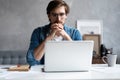 Thoughtful man looking away while sitting at his working place in office Royalty Free Stock Photo