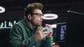 Thoughtful man looking computer pondering project at dark datacenter closeup Royalty Free Stock Photo