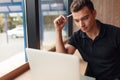 Thoughtful man looking at laptop in cafe Royalty Free Stock Photo