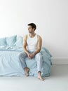 Thoughtful Man In Nightwear Sitting In Bed