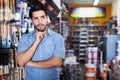 Thoughtful man in paint store Royalty Free Stock Photo