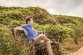 Thoughtful man sitting on a wooden bench in nature Royalty Free Stock Photo