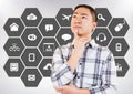 Thoughtful man standing against various applications icon