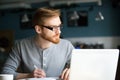 Thoughtful man thinking of new idea writing notes in cafe Royalty Free Stock Photo