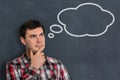 Thoughtful man with thought bubble on blackboard Royalty Free Stock Photo