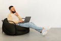 Thoughtful Man Using Laptop Thinking Sitting In Chair At Home Royalty Free Stock Photo