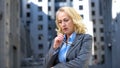Thoughtful mature lady in business suit looking worried, work pressure, stress Royalty Free Stock Photo