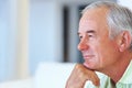 Thoughtful mature man. Closeup of thoughtful mature man at home looking away in deep thought. Royalty Free Stock Photo