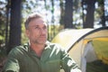 Thoughtful mature man on sunny day in forest Royalty Free Stock Photo