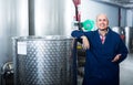 Thoughtful mature man working in wine secondary fermentation section Royalty Free Stock Photo