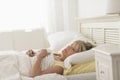 Thoughtful Mature Woman Lying On Bed Royalty Free Stock Photo