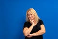 Thoughtful middle-aged businesswoman resting her chin on her hand, close up head and shoulders portrait with copy space. Royalty Free Stock Photo