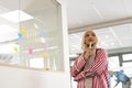 Thoughtful middle-east woman in hijab in office brainstorming with post it card