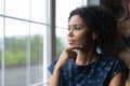 Thoughtful millennial african american woman standing near window. Royalty Free Stock Photo