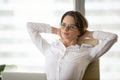 Thoughtful businesswoman leaning in chair relaxing after work