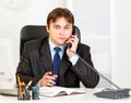 Thoughtful modern business man talking on phone Royalty Free Stock Photo