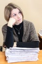 Thoughtful office employee sitting next to documents