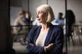 Thoughtful old businesswoman ceo looking through window thinking of leadership Royalty Free Stock Photo