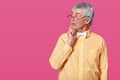 Thoughtful old man with black rounded glasses on nose. Elderly senior looks aside and keeps right hand on chin. Grey haired Royalty Free Stock Photo