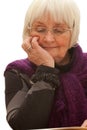 Thoughtful older woman reading a book