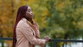 Thoughtful pensive upset young woman stands outdoors looking to side thinks about future deep in thoughts breathe fresh Royalty Free Stock Photo