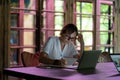 Focused pensive young woman student sitting with laptop, caucasian lady working in coworking space Royalty Free Stock Photo