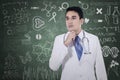 Thoughtful physician with doodle on blackboard Royalty Free Stock Photo