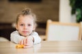 Thoughtful portrait of little girl lay on the table