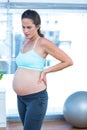 Thoughtful pregnant woman in yoga class