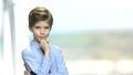 Thoughtful preteen boy on blurred background.