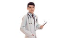 Thoughtful pretty brunette male doctor in uniform with stethoscope on his neck posing in studio isolated on white Royalty Free Stock Photo