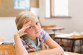 Thoughtful pupil sitting at his desk Royalty Free Stock Photo